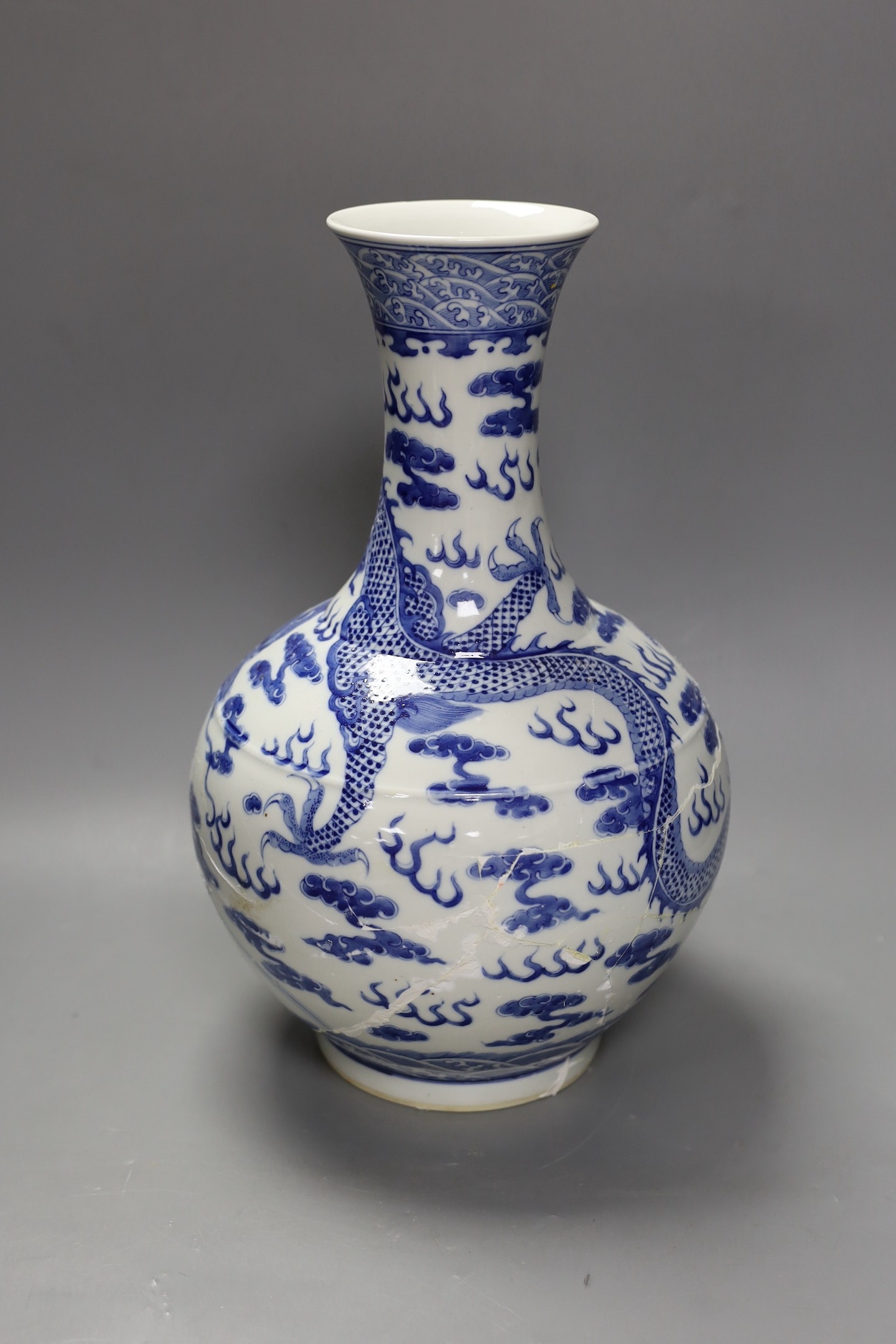 A large Chinese blue and white vase, damaged, 38cm